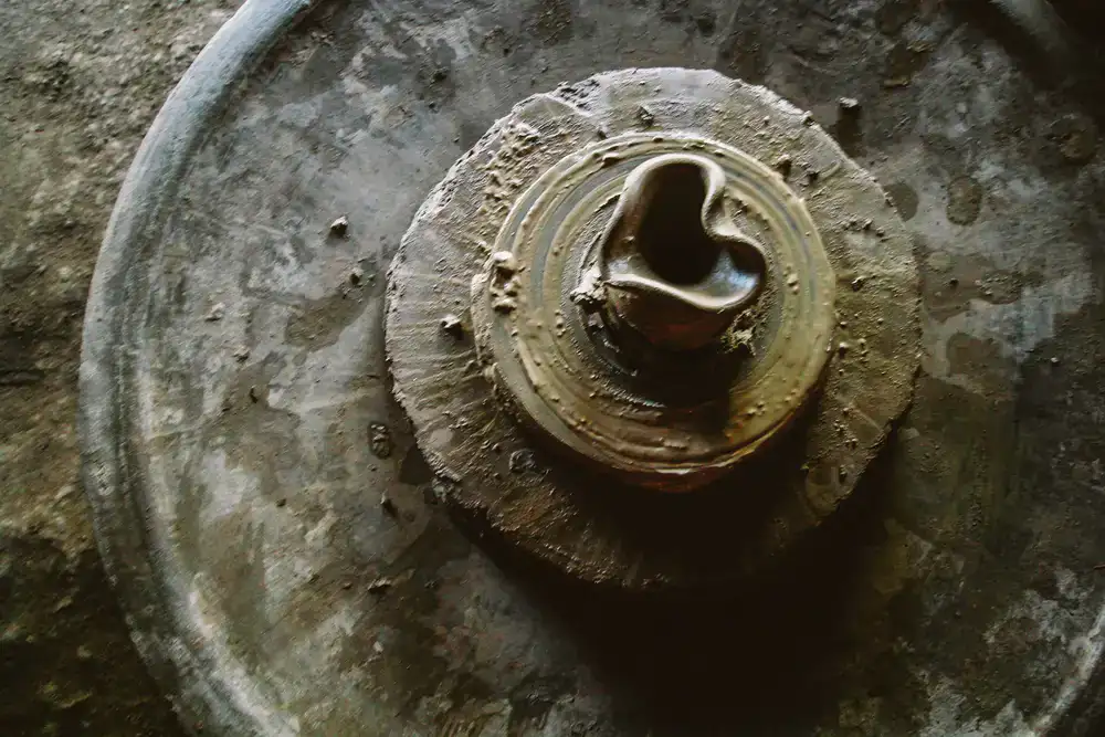 Close up of hands shaping clay on a pottery wheel
