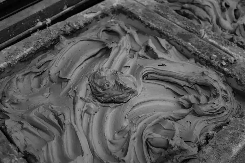 Close up of raw textured clay forms and tools