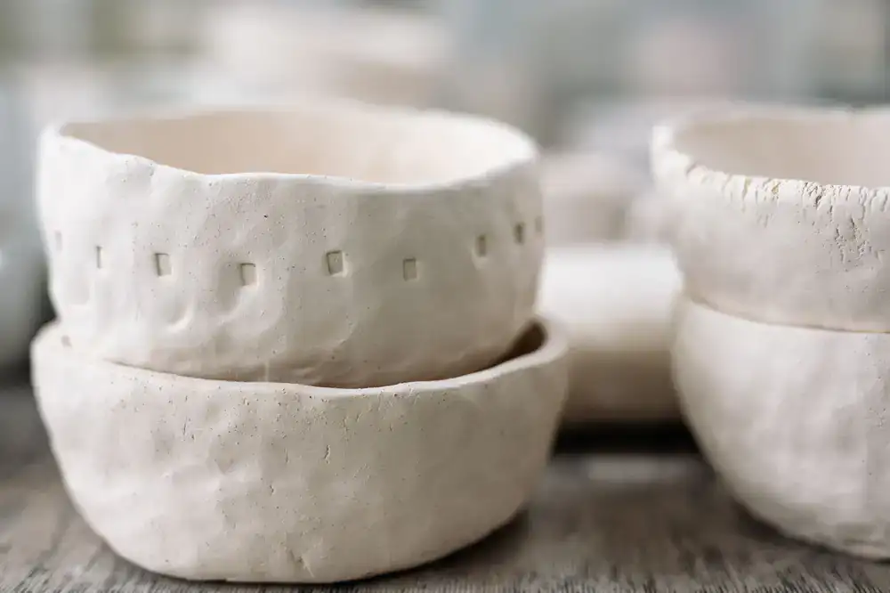 Close up of handmade ceramic bowls stacked on a studio table