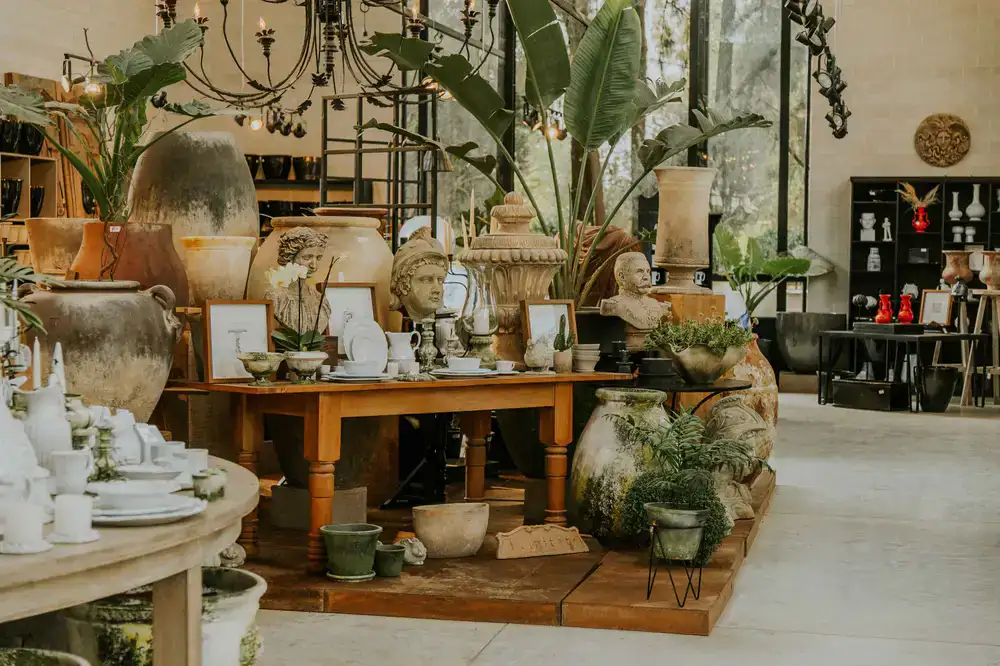 Large sculptural vases displayed gracefully on a wooden pedestal